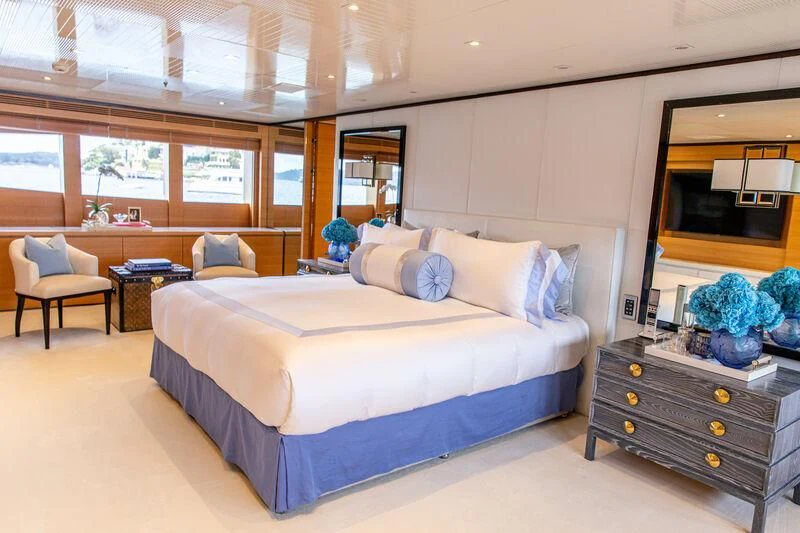 a bedroom with a bed and a desk aboard MISCHIEF Yacht for Sale