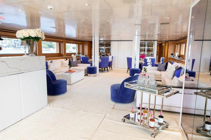 a room with a table chairs and a couch aboard MISCHIEF Yacht for Sale