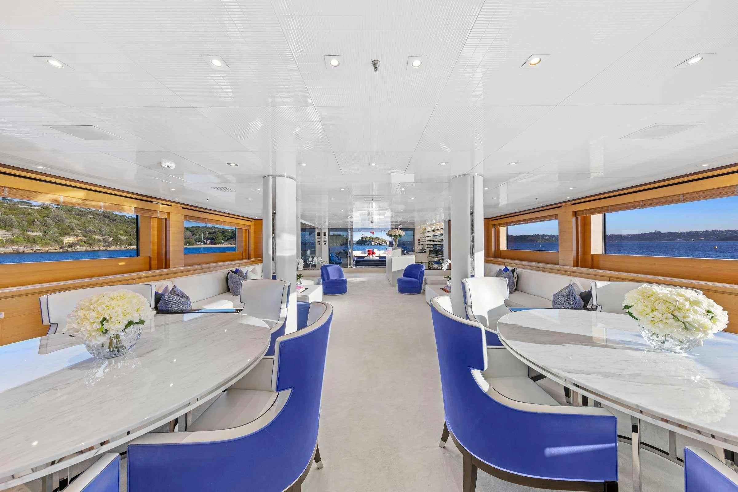 a room with tables and chairs aboard MISCHIEF Yacht for Sale