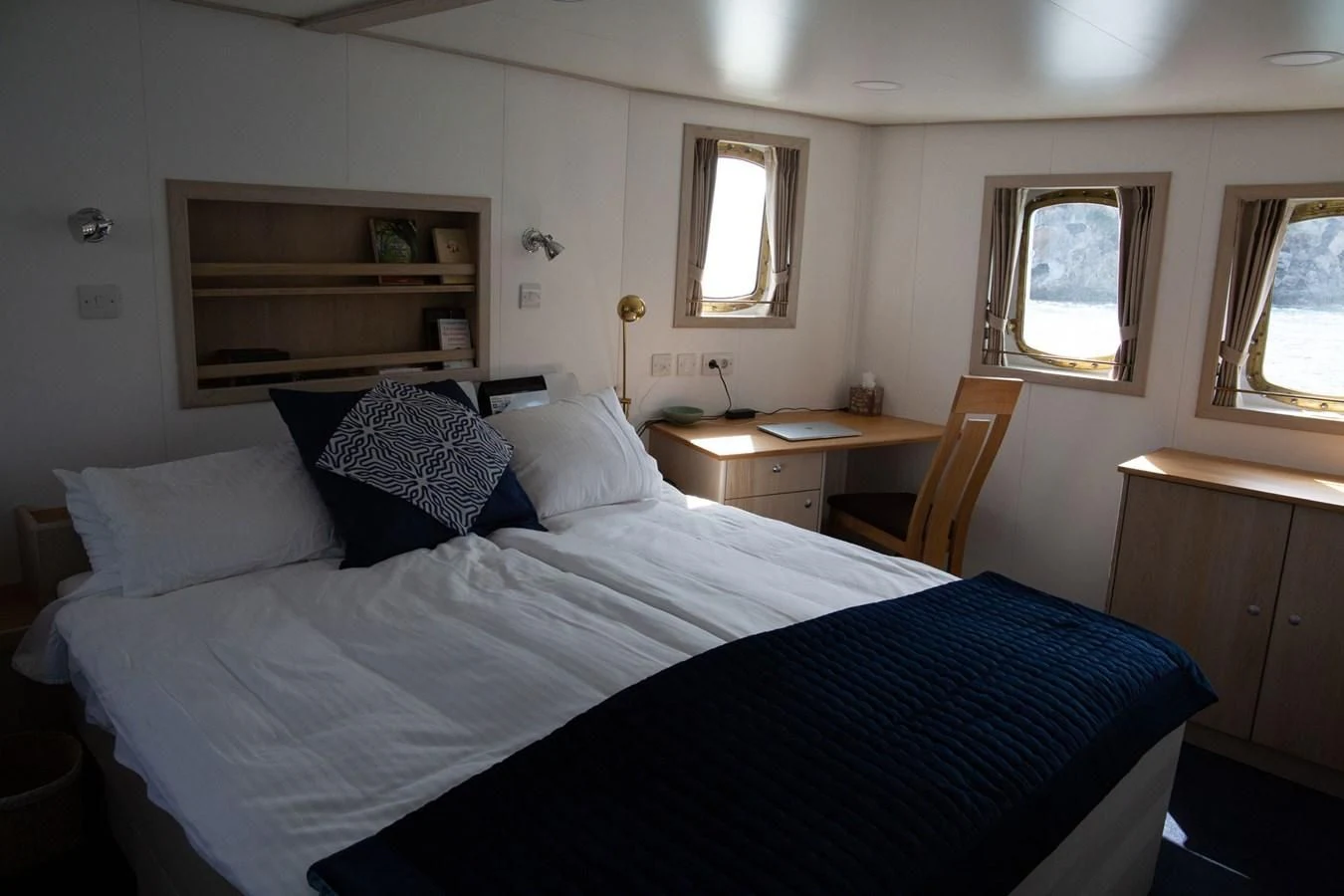 a bed with white sheets aboard SPIRIT OF GINETTE Yacht for Sale