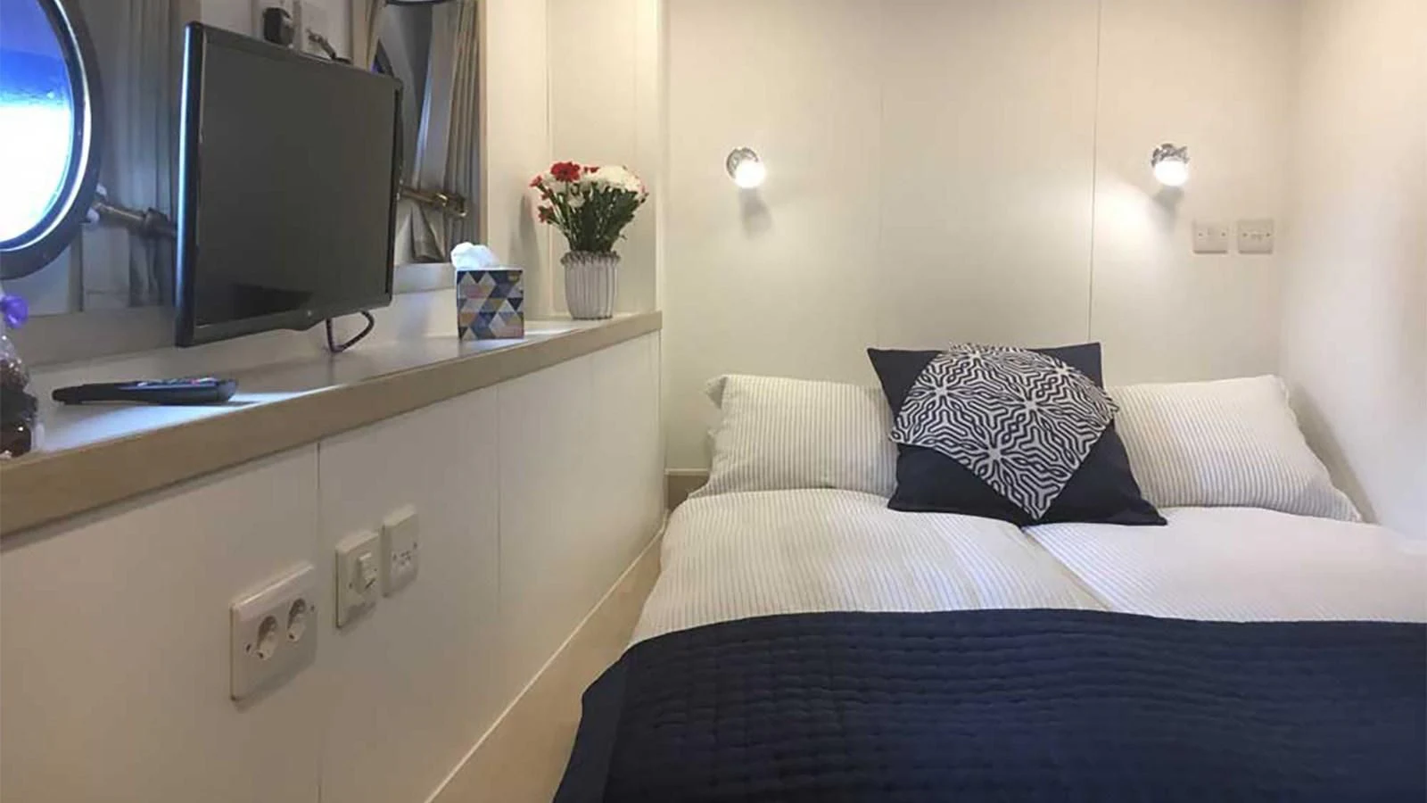 a bed with a television on the wall aboard SPIRIT OF GINETTE Yacht for Sale