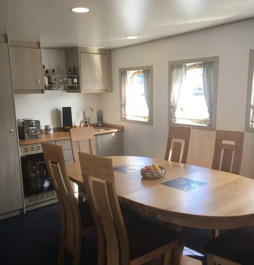 a kitchen with a dining table aboard SPIRIT OF GINETTE Yacht for Sale