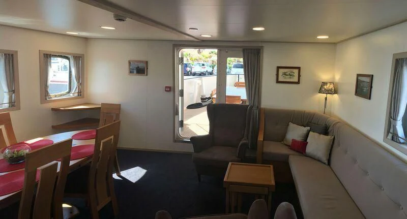 a living room with a couch and a table aboard SPIRIT OF GINETTE Yacht for Sale