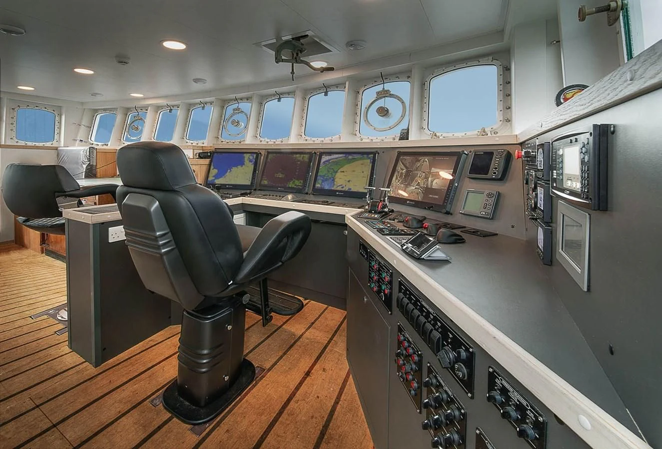 a room with a desk and chairs aboard SPIRIT OF GINETTE Yacht for Sale