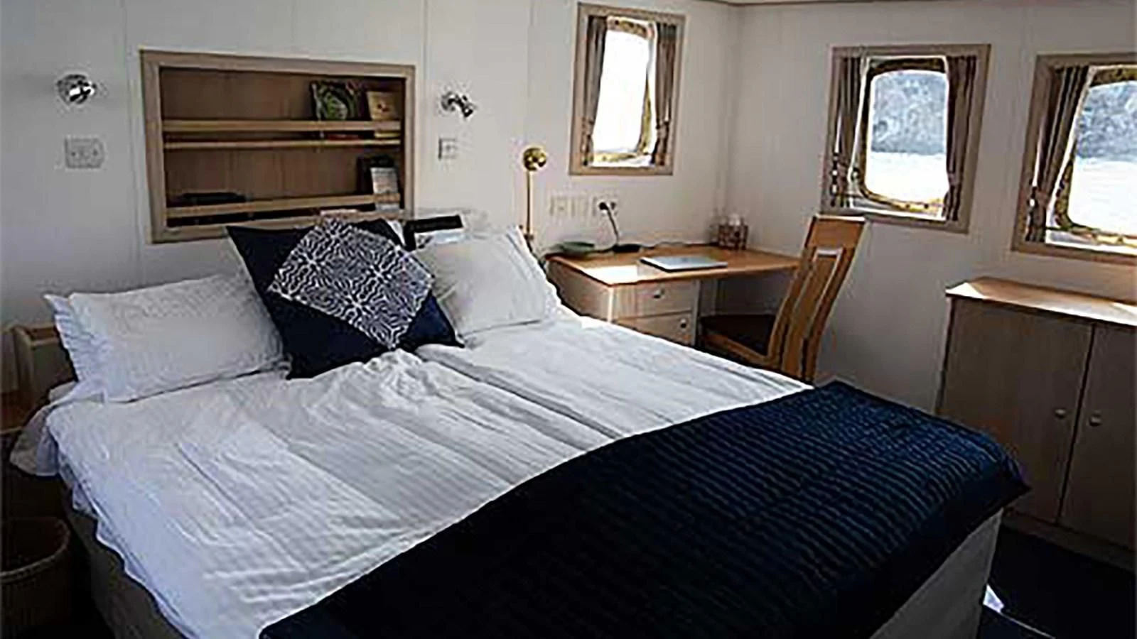 a bed with white sheets aboard SPIRIT OF GINETTE Yacht for Sale