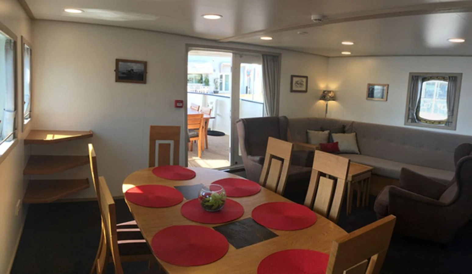 a living room with a dining table and chairs aboard SPIRIT OF GINETTE Yacht for Sale