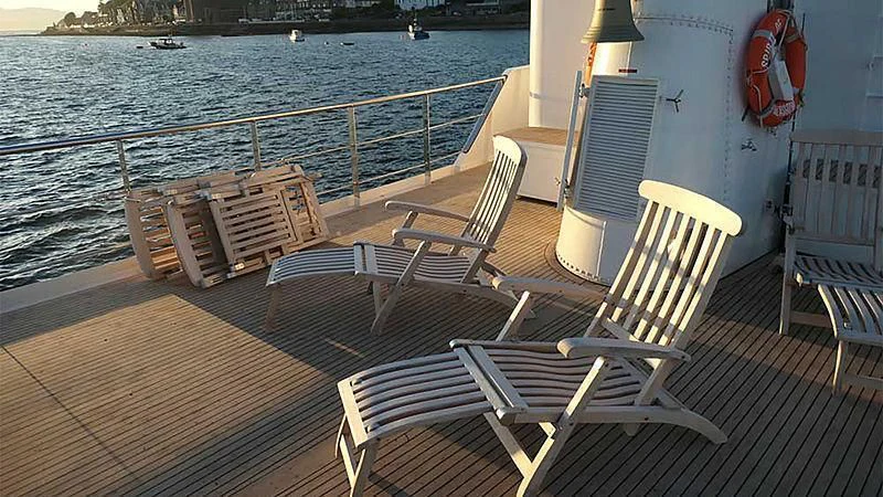 a deck with chairs on it by the water aboard SPIRIT OF GINETTE Yacht for Sale