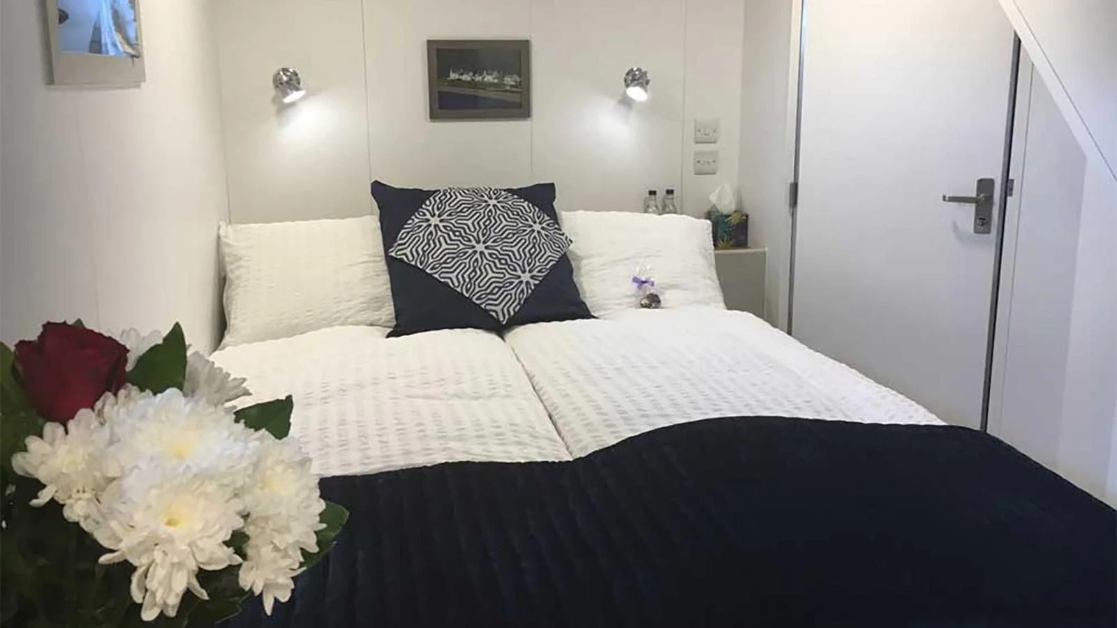 a bed with white flowers aboard SPIRIT OF GINETTE Yacht for Sale
