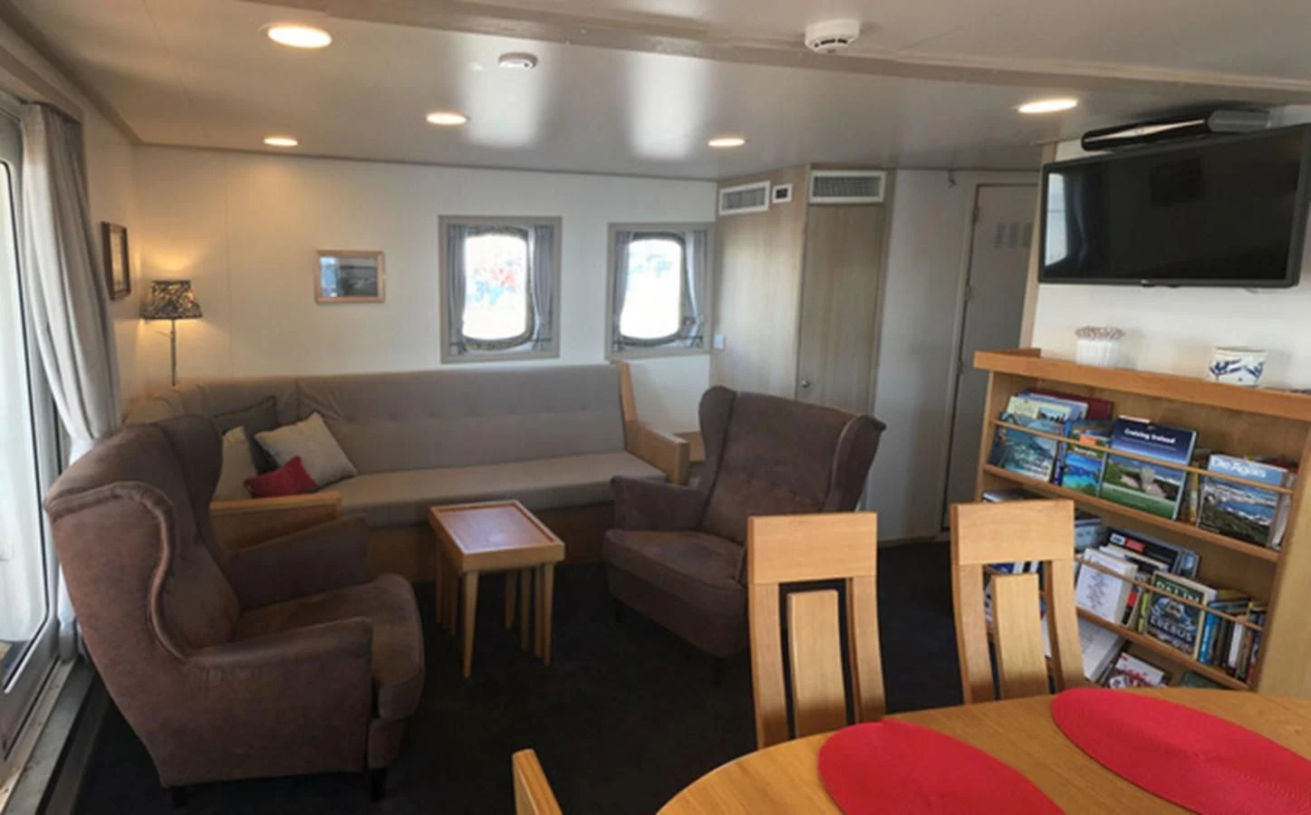 a living room with a couch and a tv aboard SPIRIT OF GINETTE Yacht for Sale