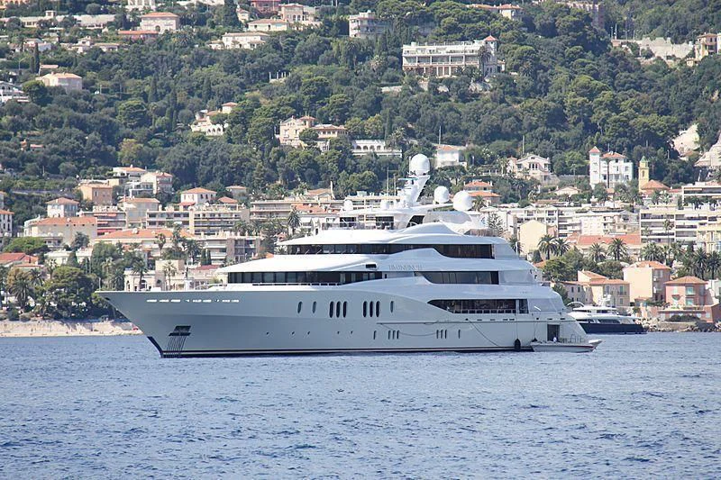 a large white boat on the water aboard EMINENCE Yacht for Sale