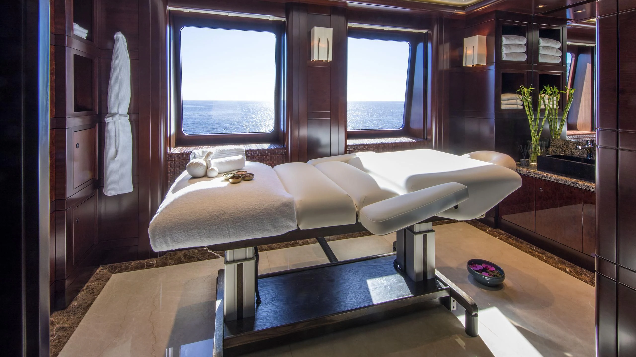 a room with a bed and a window aboard EMINENCE Yacht for Sale