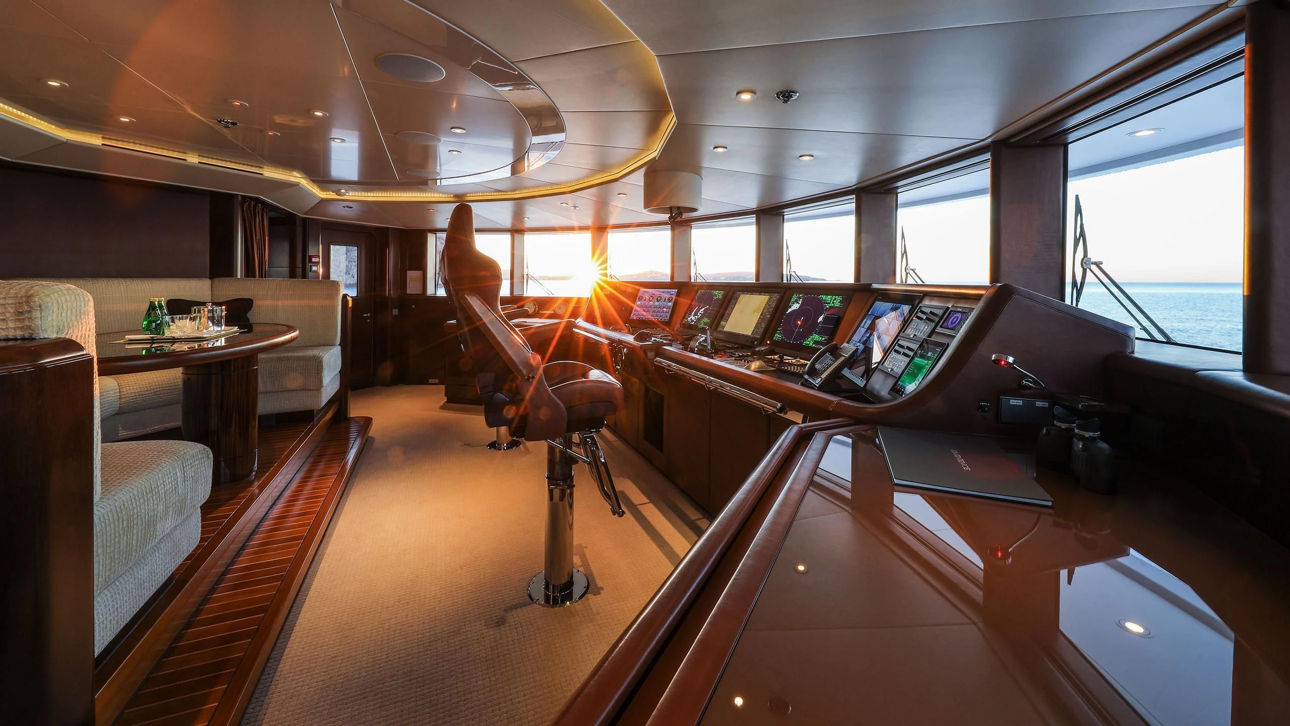 a room with a desk and chairs aboard EMINENCE Yacht for Sale