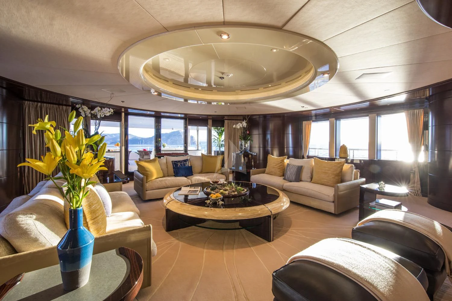 a living room with a large chandelier aboard EMINENCE Yacht for Sale