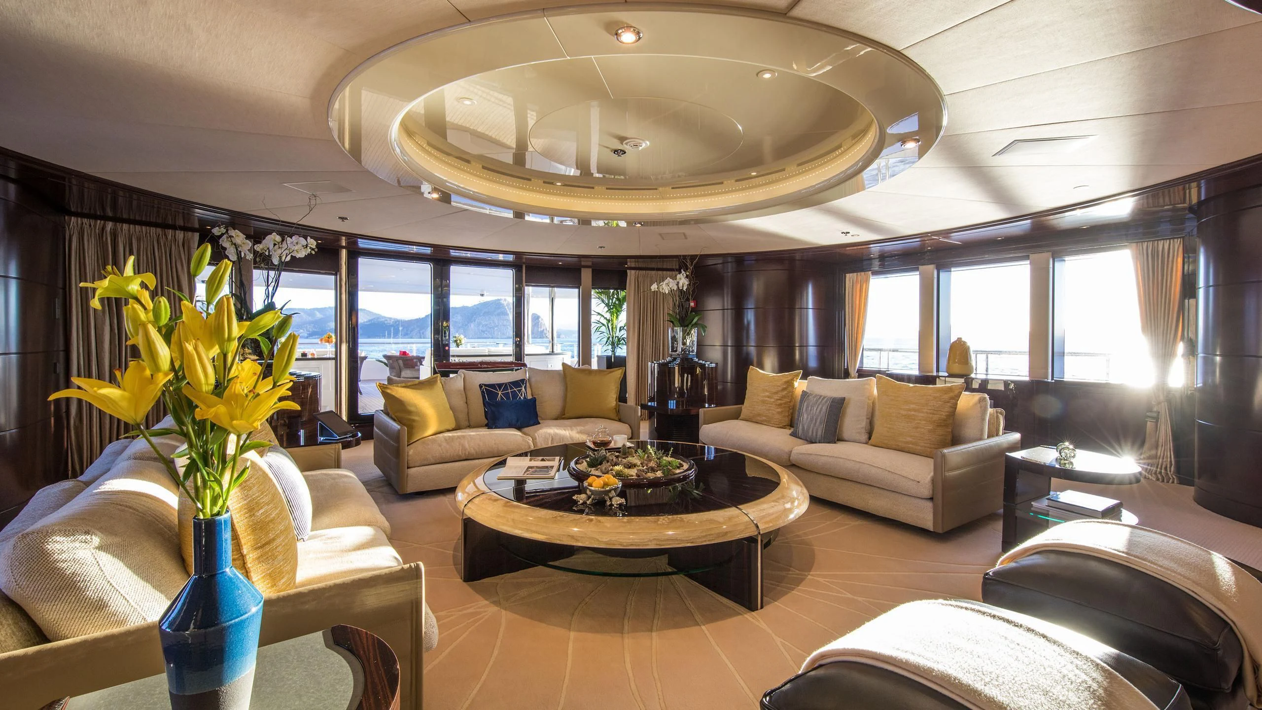 a living room with a large chandelier aboard EMINENCE Yacht for Sale