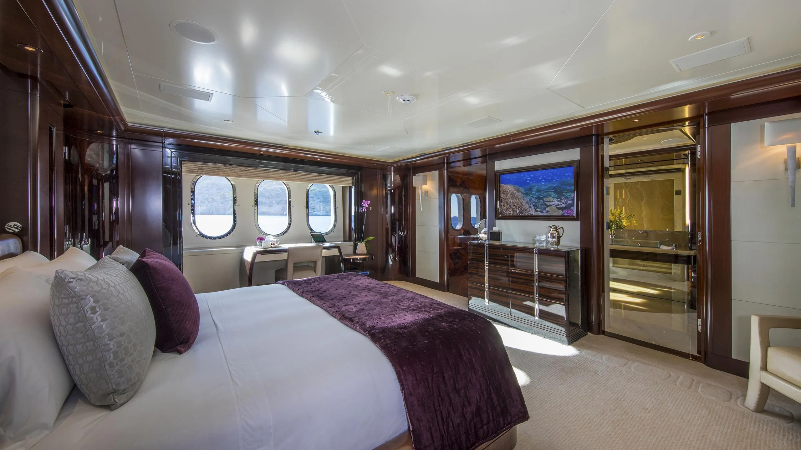 a room with a bed and a tv aboard EMINENCE Yacht for Sale