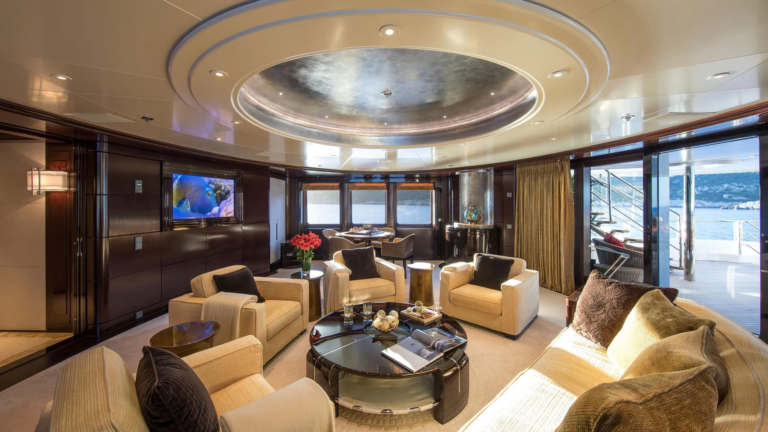 a living room with a large chandelier aboard EMINENCE Yacht for Sale