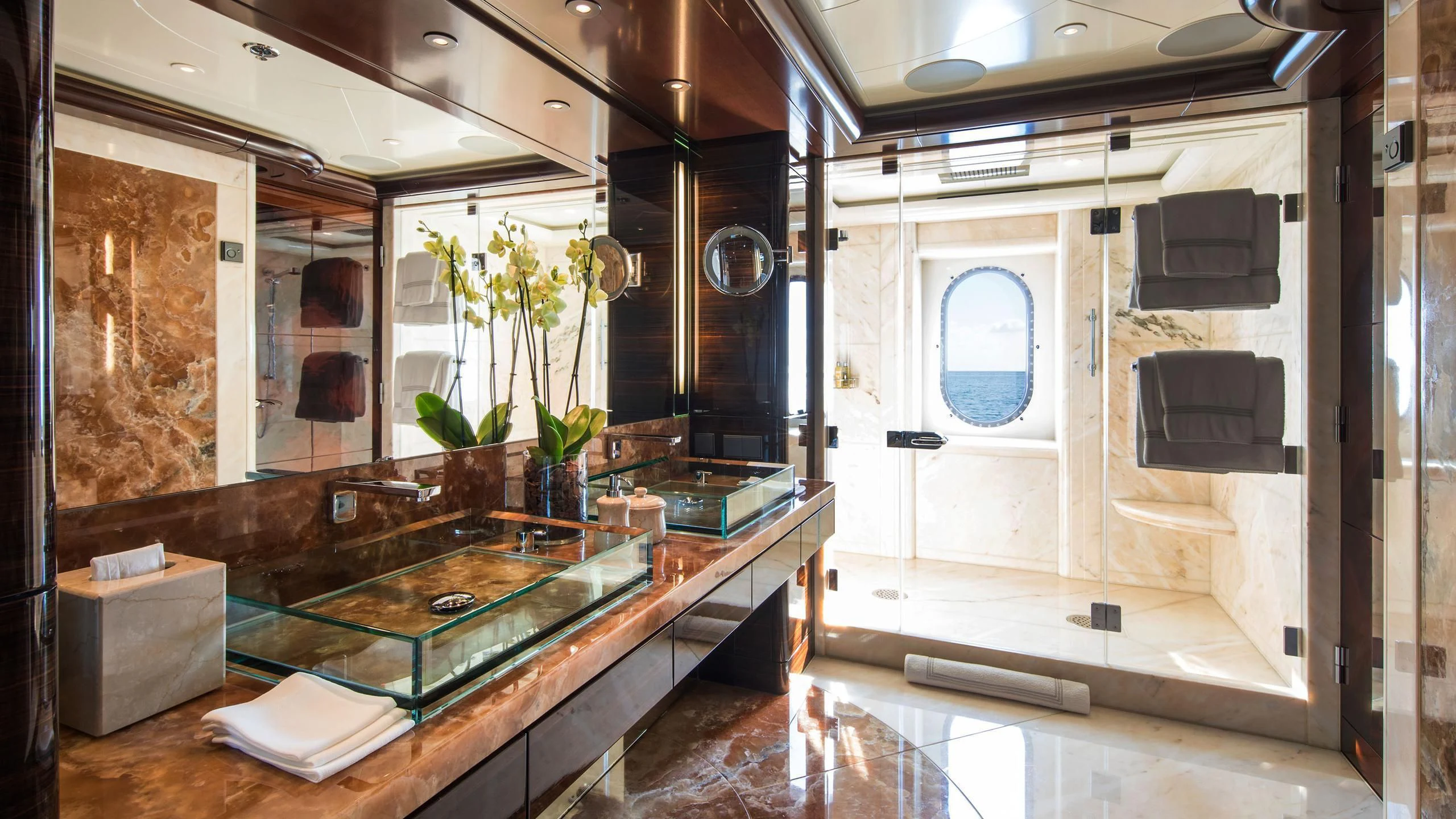 a bathroom with a countertop sink and a mirror aboard EMINENCE Yacht for Sale