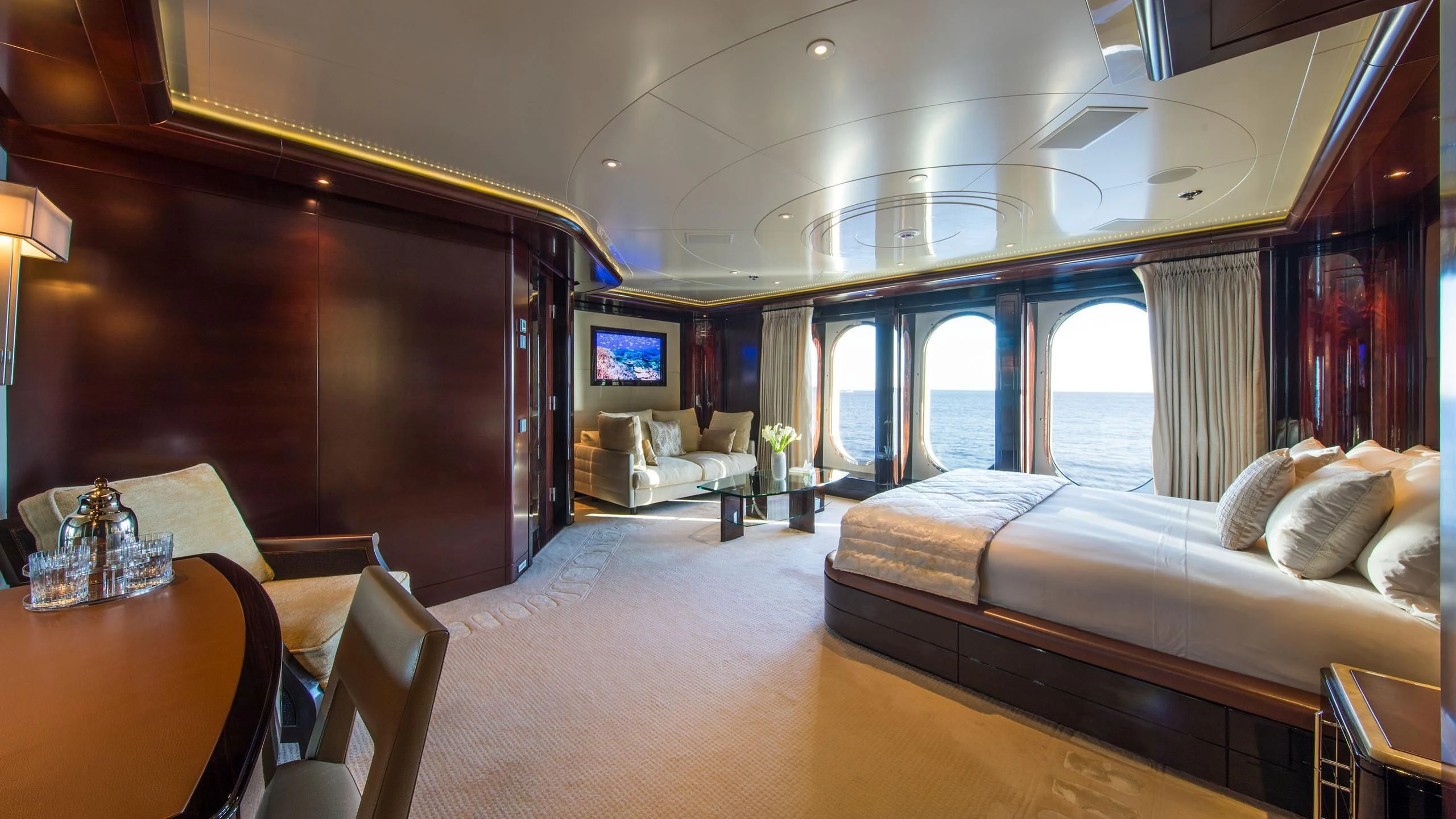 a room with a bed and a couch aboard EMINENCE Yacht for Sale