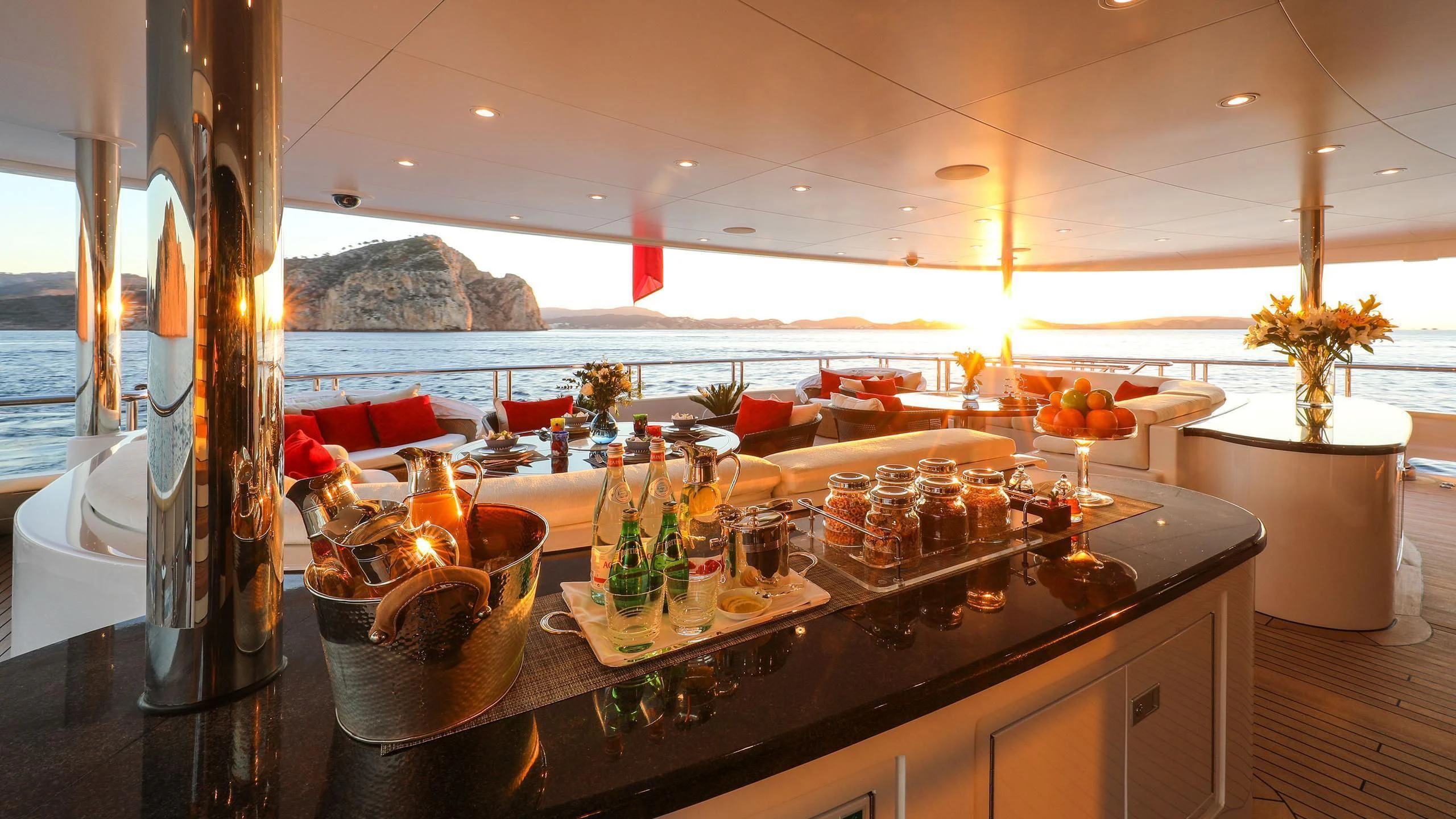 a bar with many glasses and bottles aboard EMINENCE Yacht for Sale