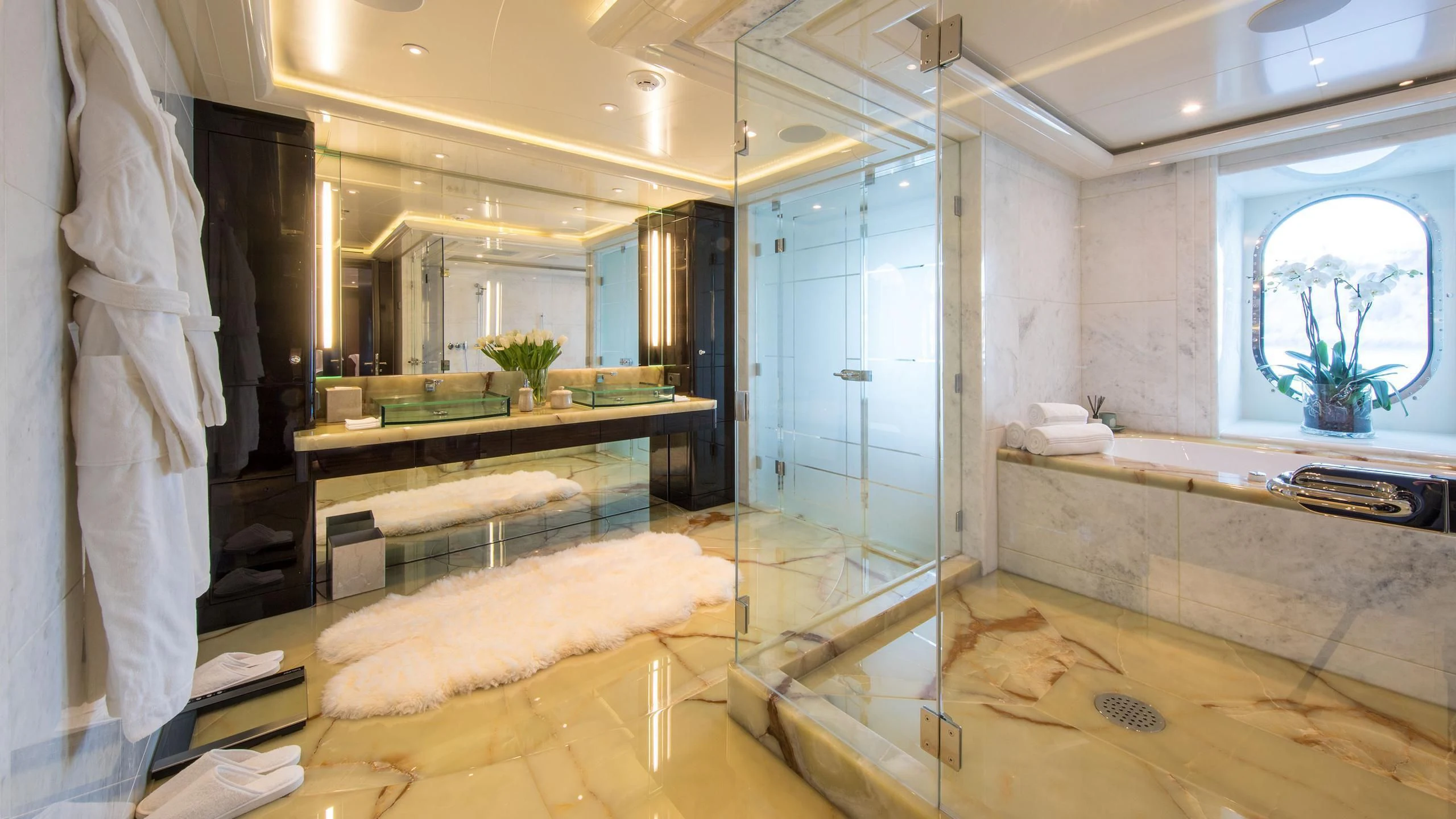 a bathroom with a countertop sink and a mirror aboard EMINENCE Yacht for Sale