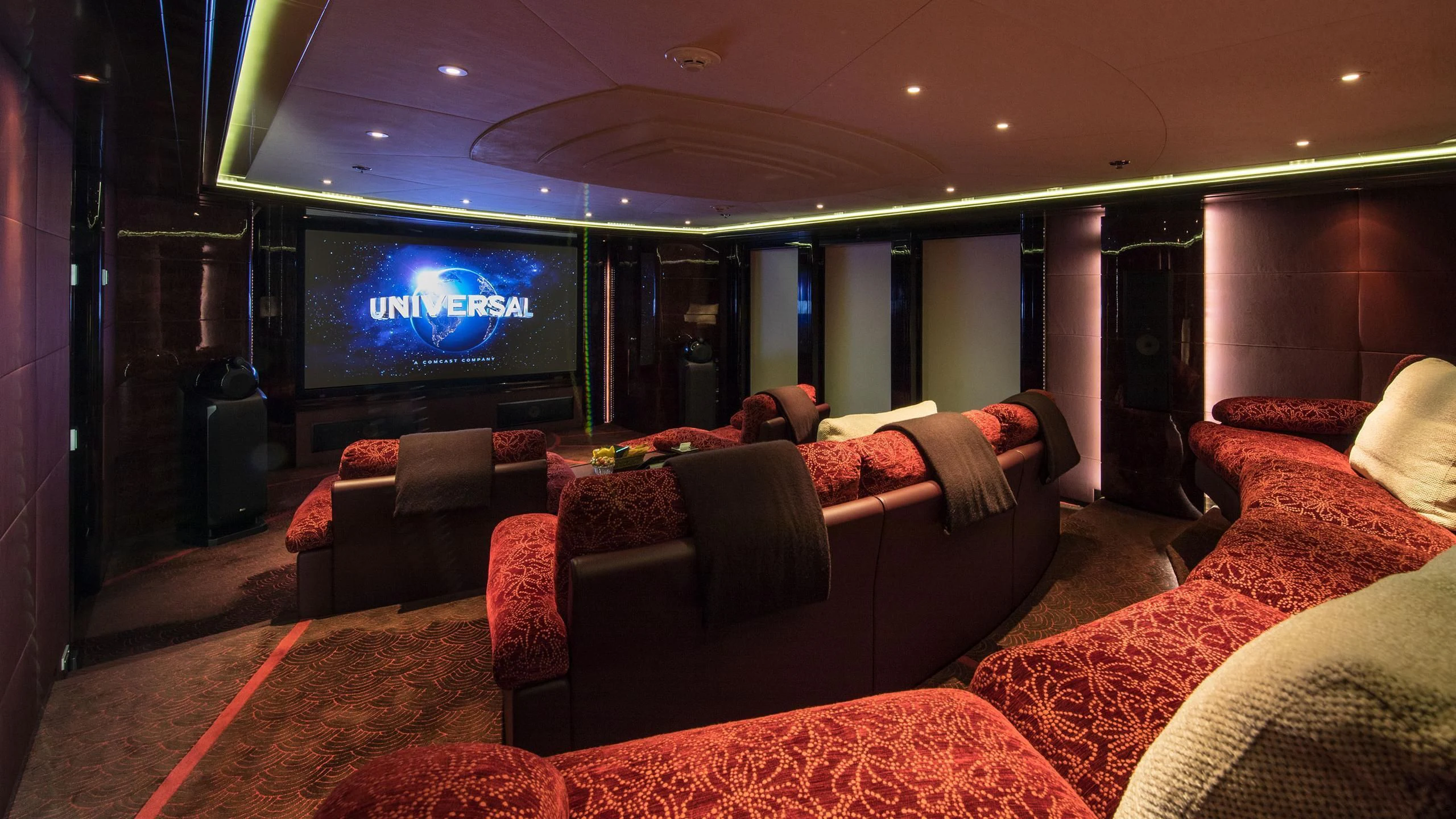 a living room with a large screen aboard EMINENCE Yacht for Sale