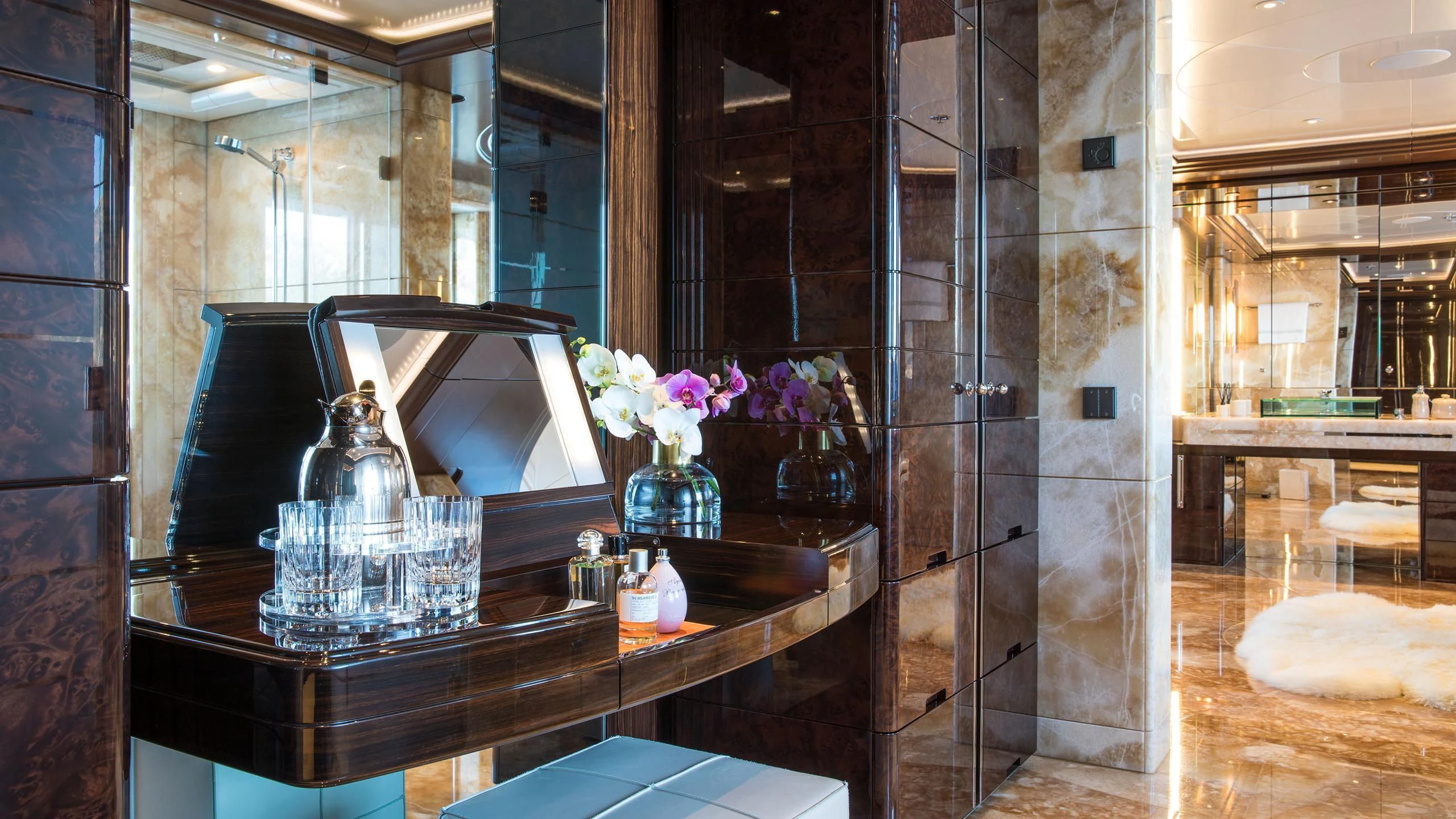 a room with a glass display case and a table with flowers aboard EMINENCE Yacht for Sale