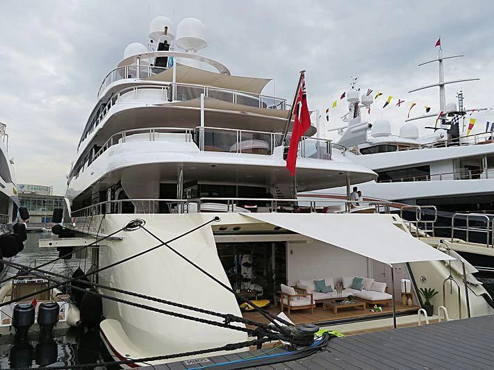 a large white boat with flags aboard EMINENCE Yacht for Sale