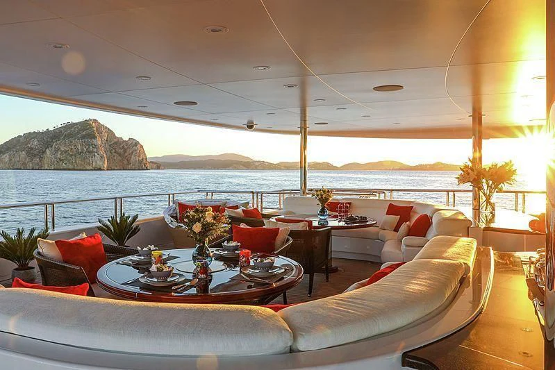 a room with a couch and a table and chairs aboard EMINENCE Yacht for Sale