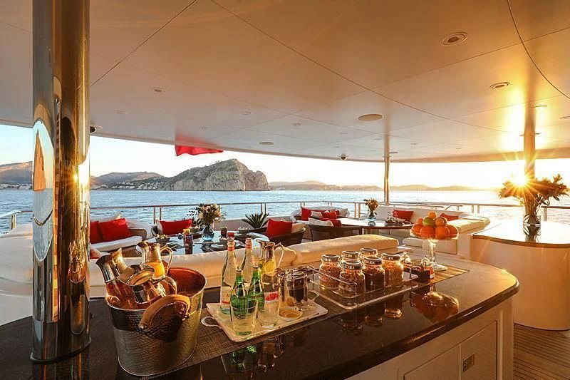 a table with glasses and bottles aboard EMINENCE Yacht for Sale