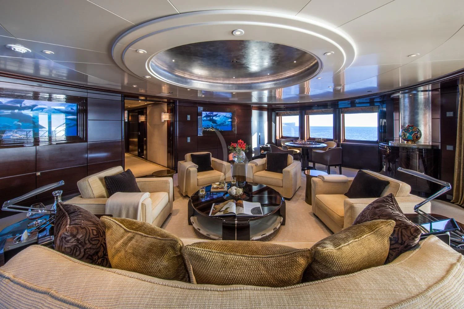 a living room with a large chandelier aboard EMINENCE Yacht for Sale