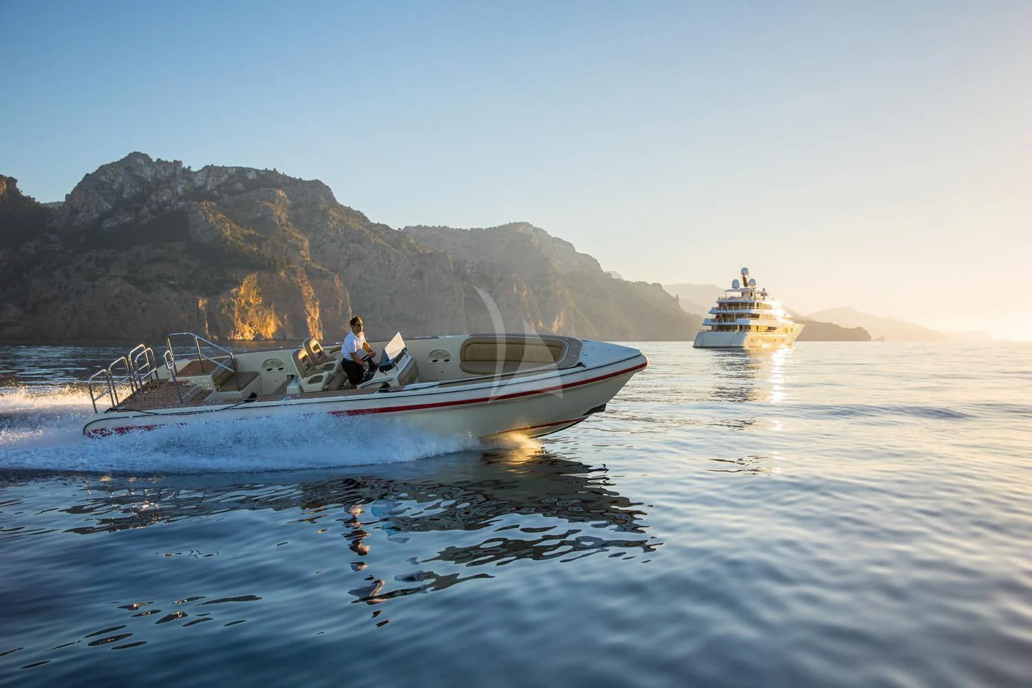 a couple of boats on the water aboard EMINENCE Yacht for Sale