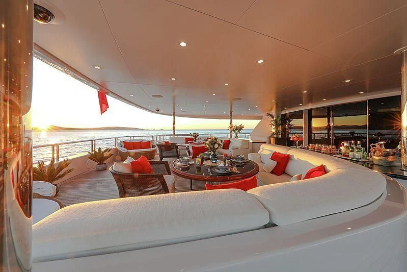 a room with couches and a table aboard EMINENCE Yacht for Sale