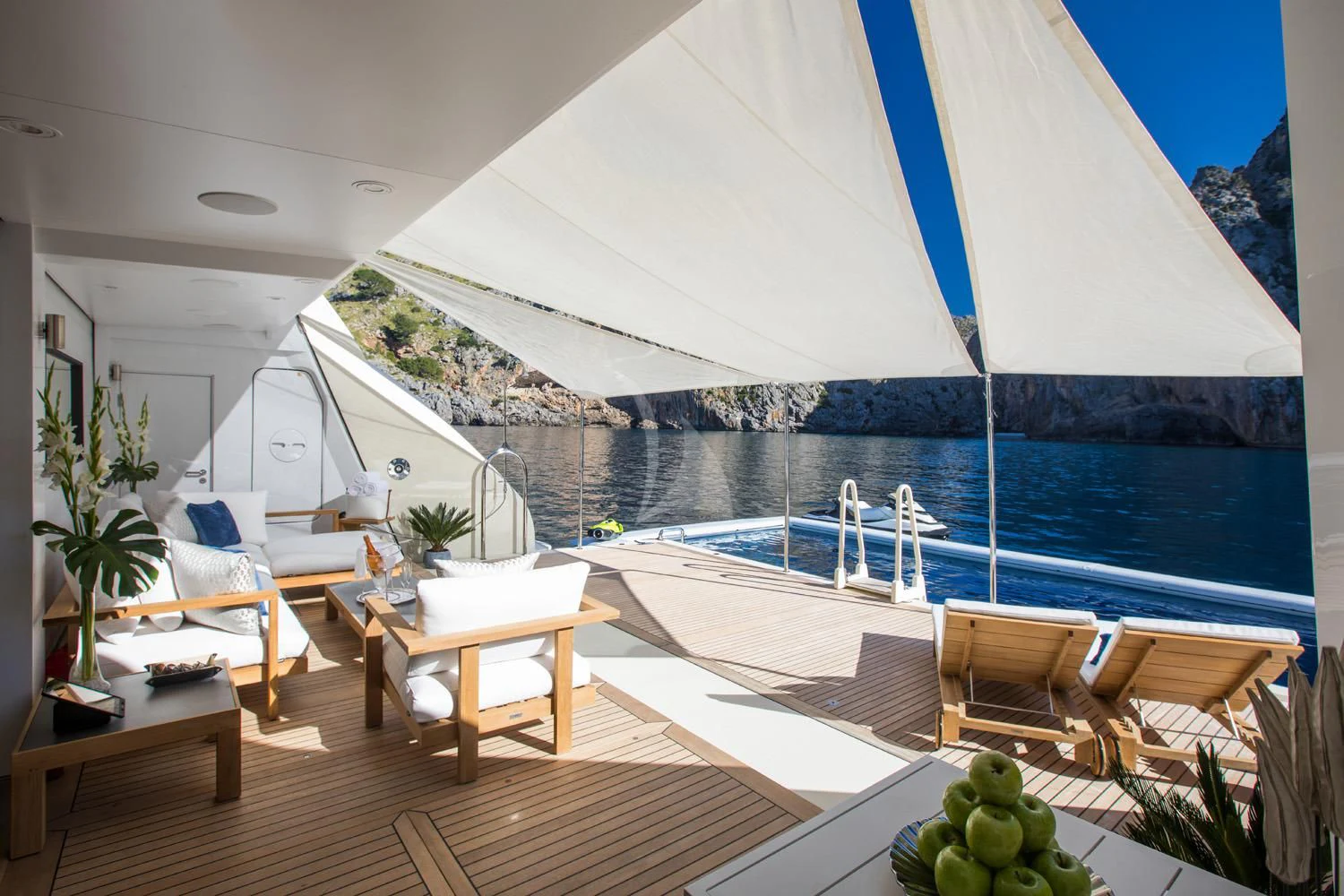 a room with a table and chairs and a large white tent aboard EMINENCE Yacht for Sale