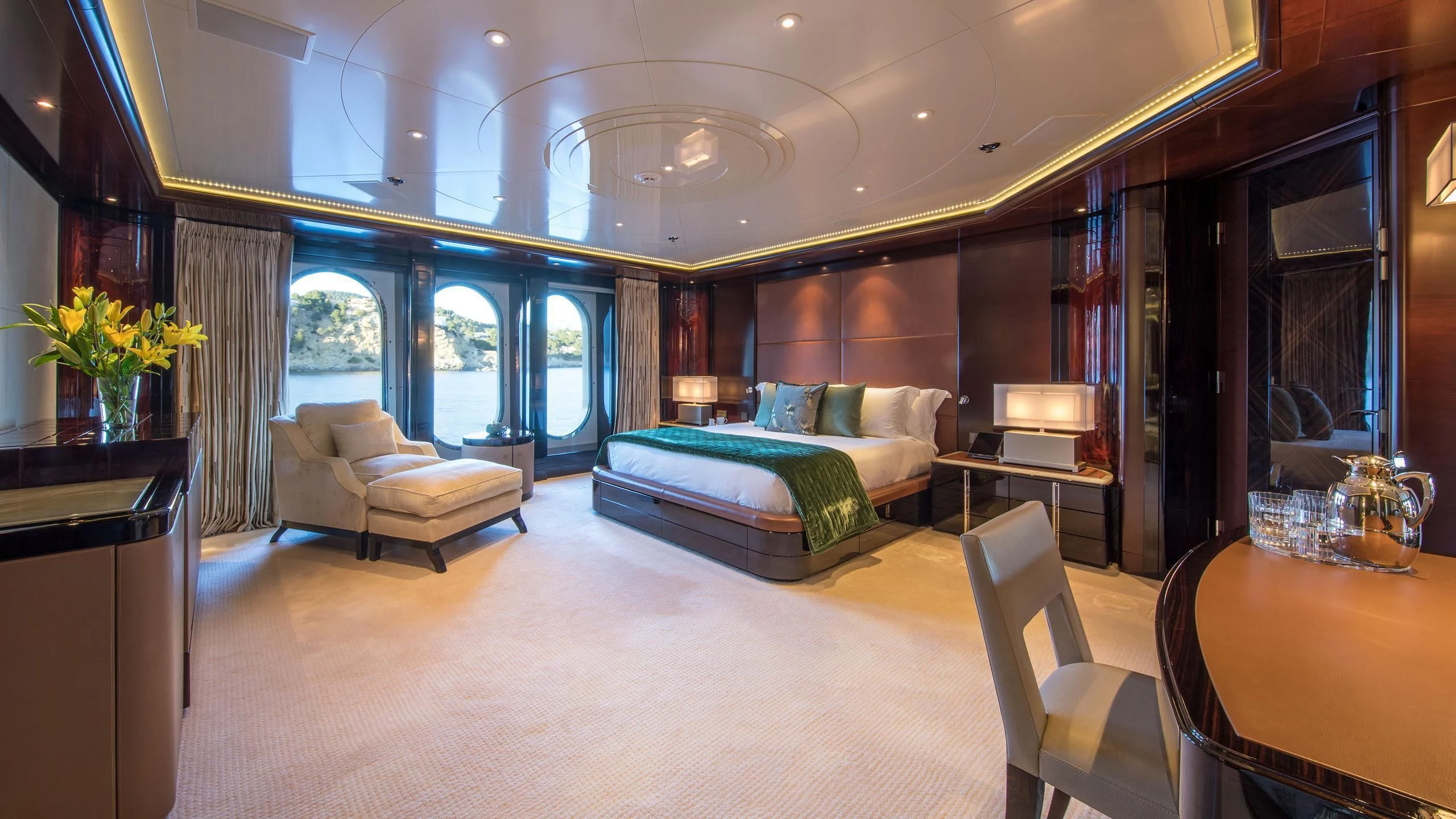 a large bedroom with a bed and a large window aboard EMINENCE Yacht for Sale
