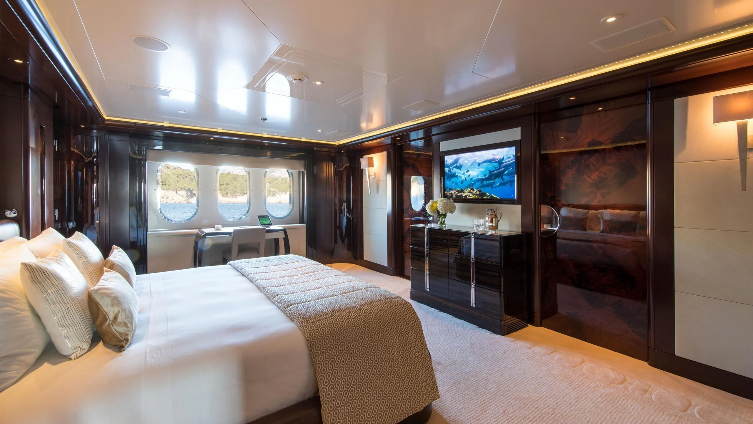 a room with a bed and a tv aboard EMINENCE Yacht for Sale