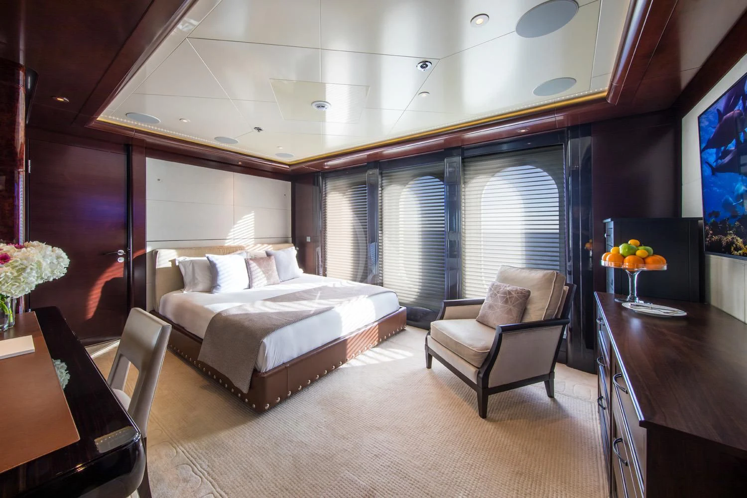 a room with a bed and a chair aboard EMINENCE Yacht for Sale