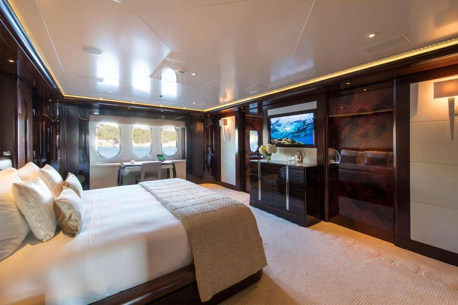 a room with a bed and a tv aboard EMINENCE Yacht for Sale