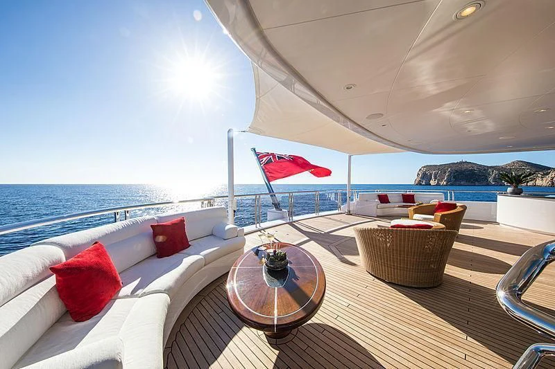 a room with a couch and a table and chairs aboard EMINENCE Yacht for Sale