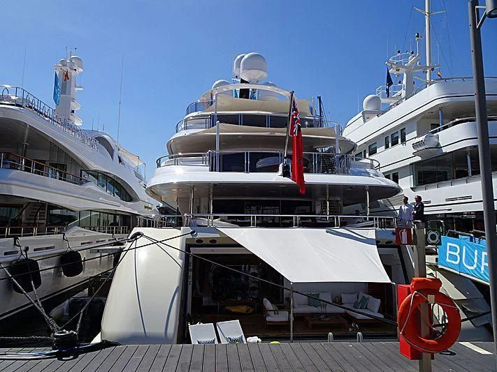 a large boat docked at a pier aboard EMINENCE Yacht for Sale