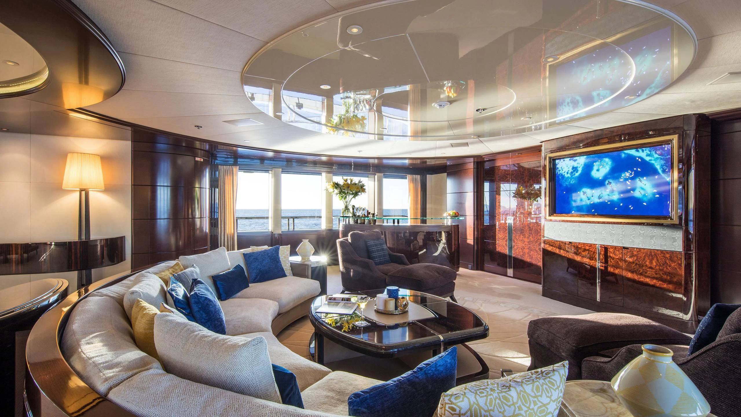 a living room with a large screen aboard EMINENCE Yacht for Sale