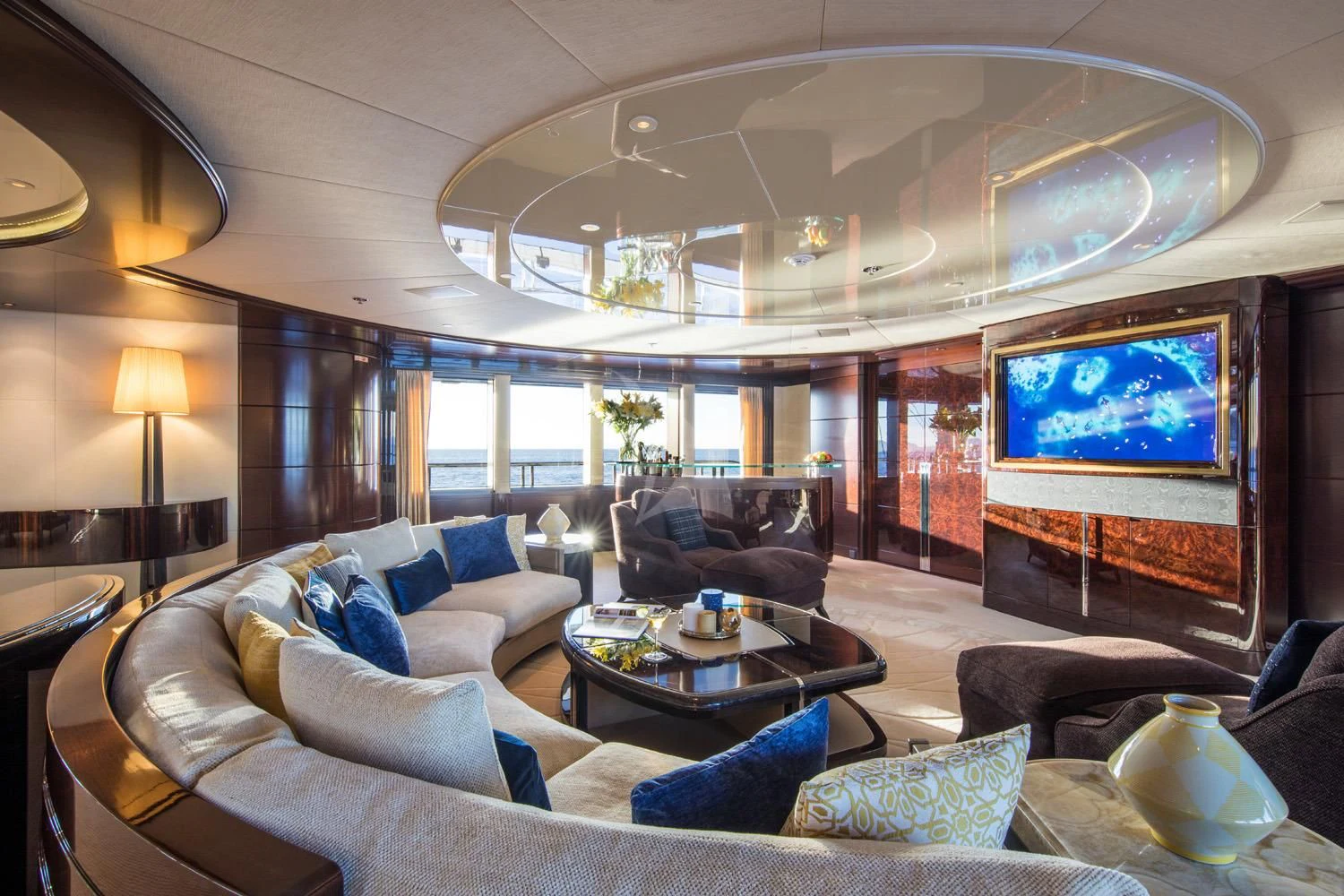 a living room with a large screen aboard EMINENCE Yacht for Sale