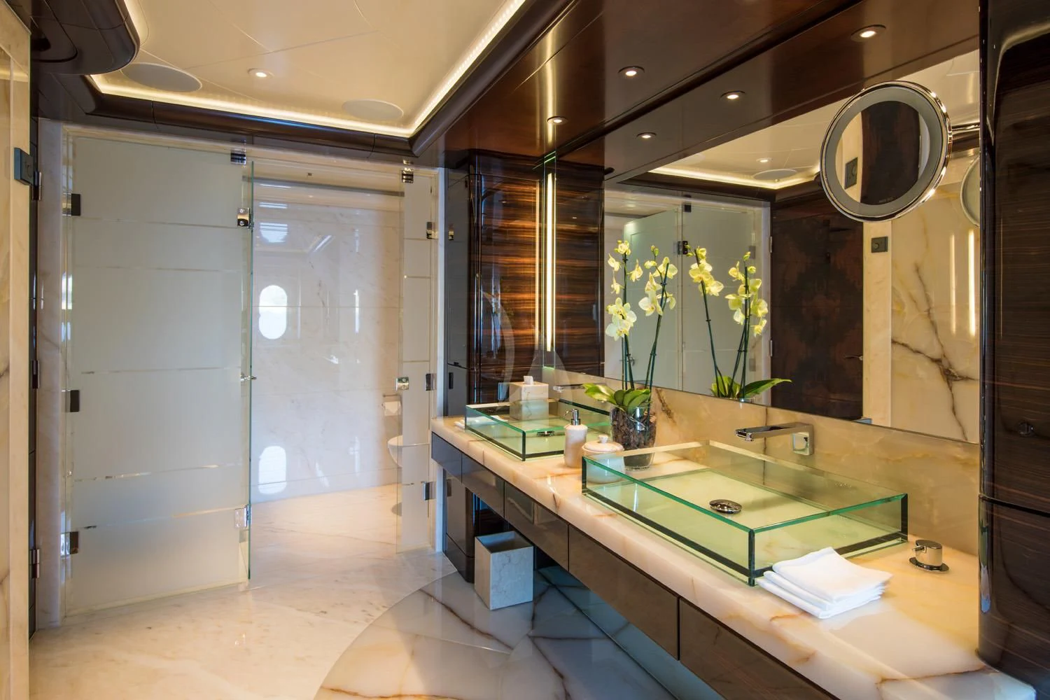 a bathroom with a large mirror aboard EMINENCE Yacht for Sale