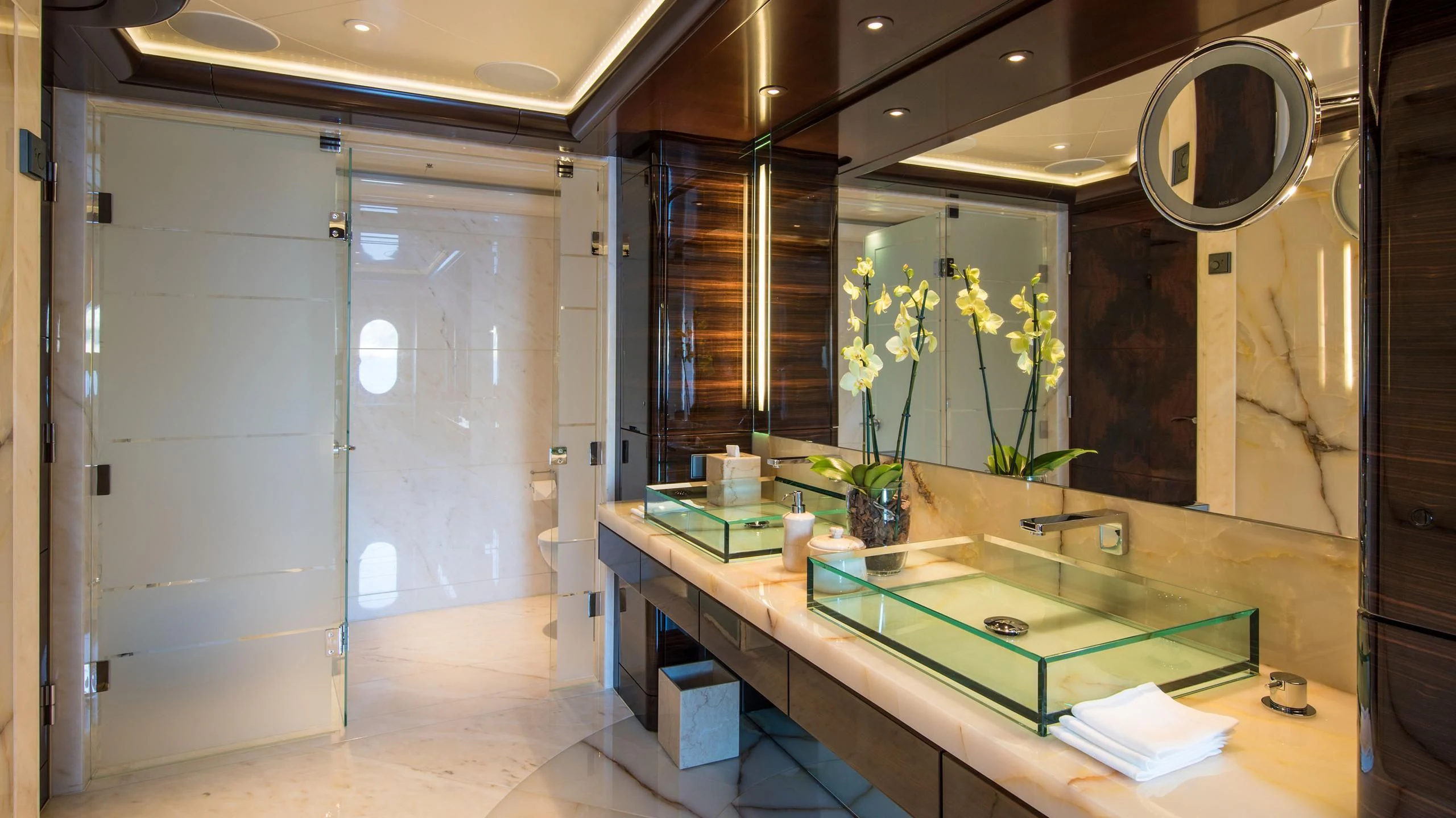 a bathroom with a large mirror aboard EMINENCE Yacht for Sale