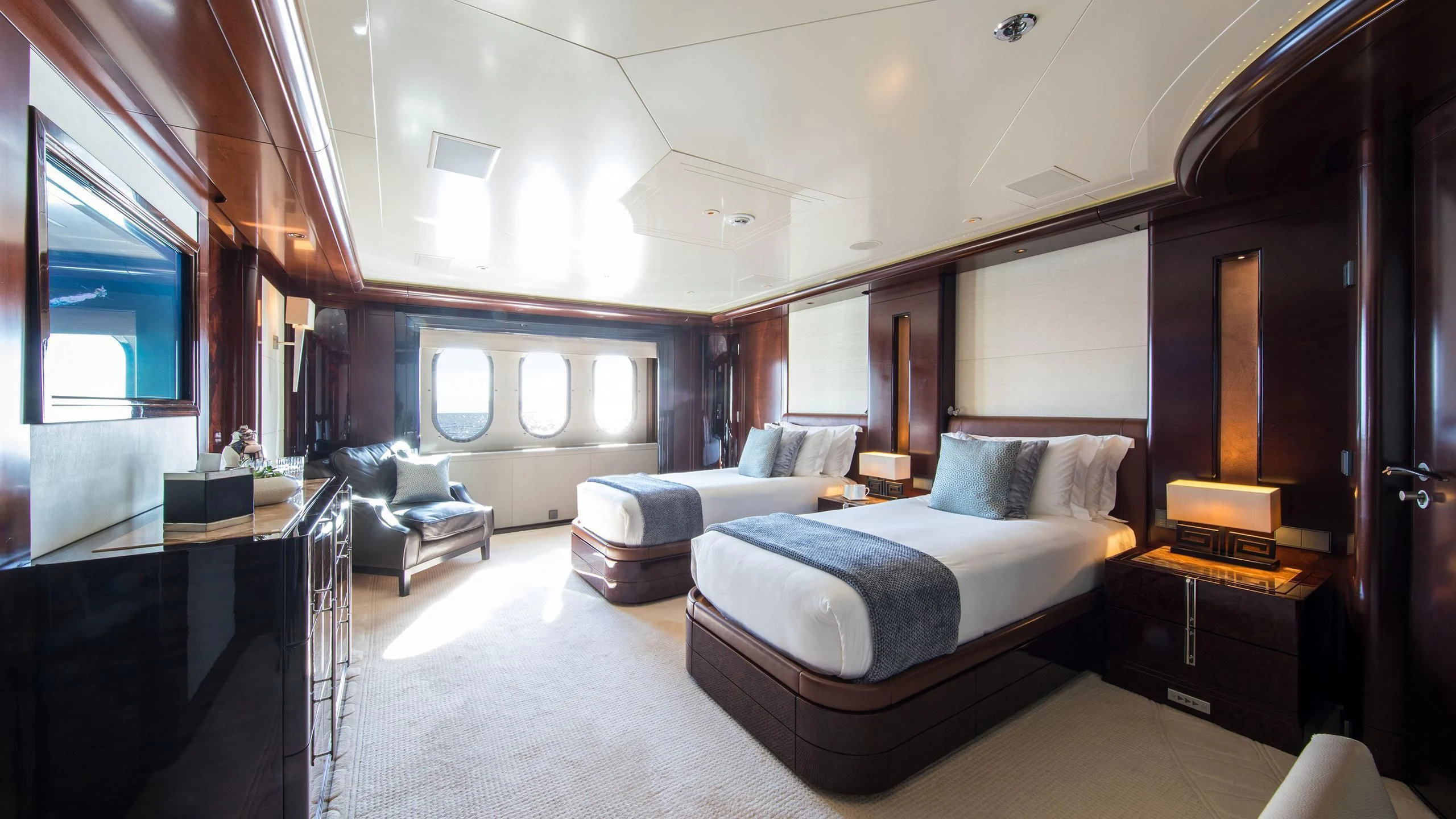 a room with a bed and a desk aboard EMINENCE Yacht for Sale