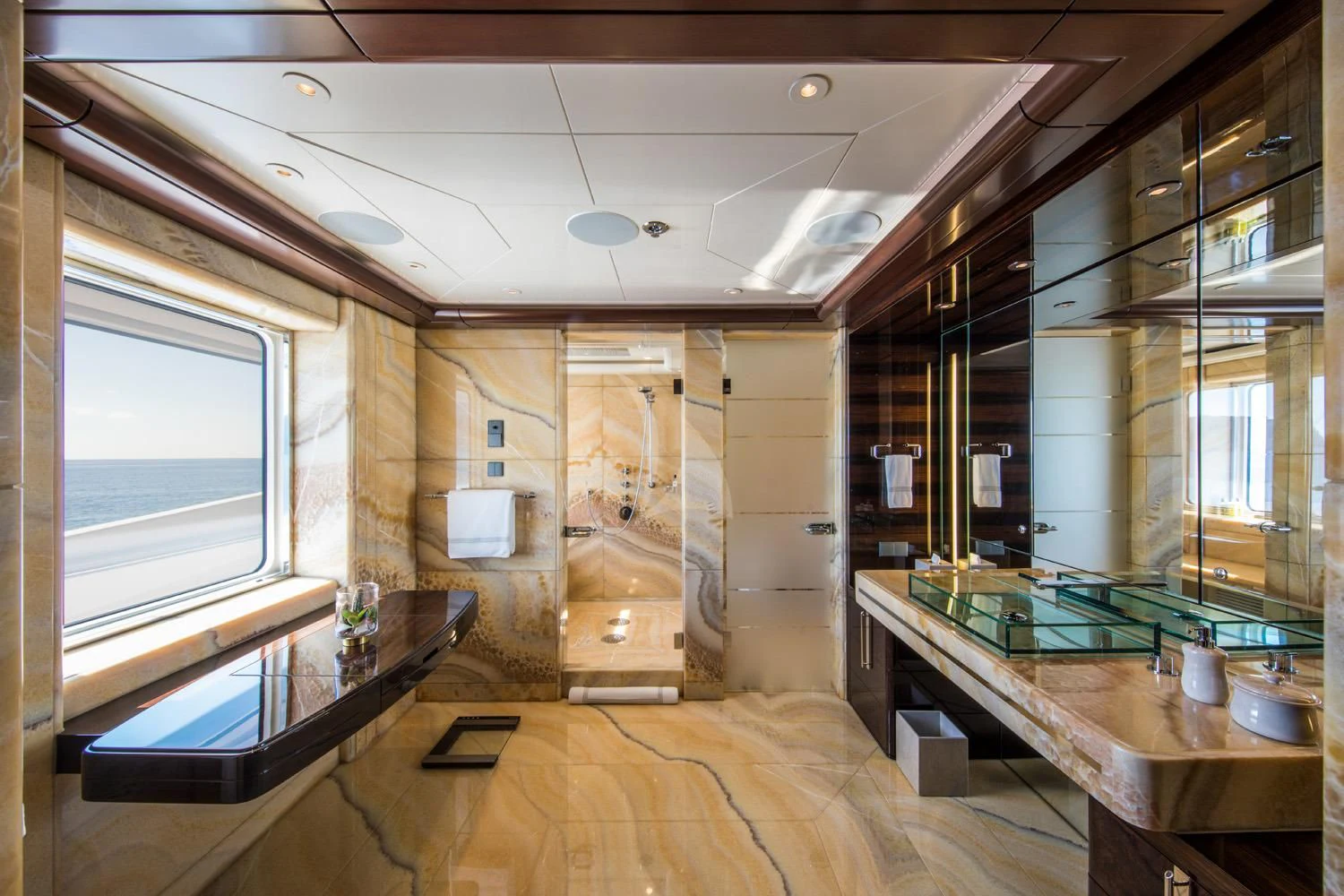 a room with a large window and a table with chairs aboard EMINENCE Yacht for Sale