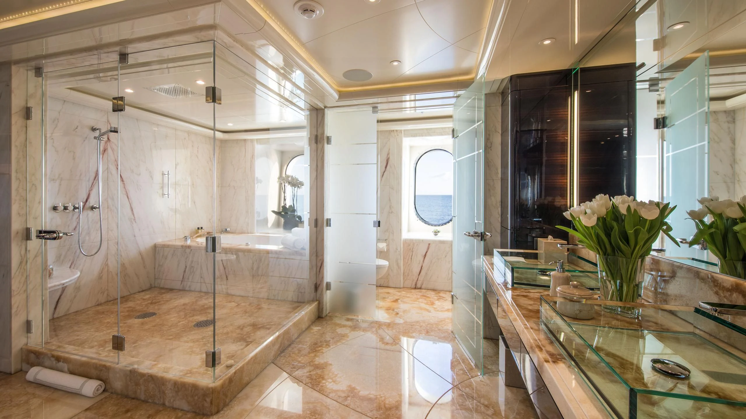 a bathroom with a glass table aboard EMINENCE Yacht for Sale