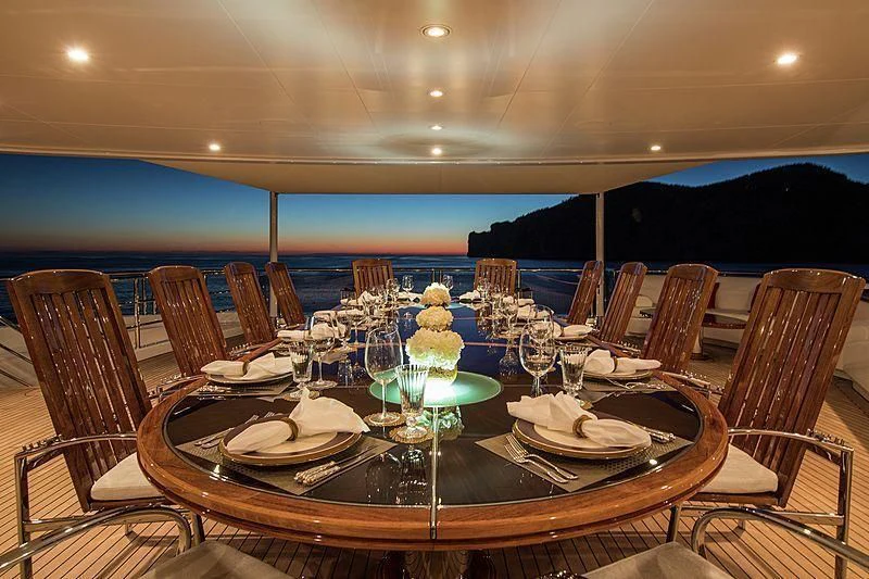 a table set for a dinner party aboard EMINENCE Yacht for Sale