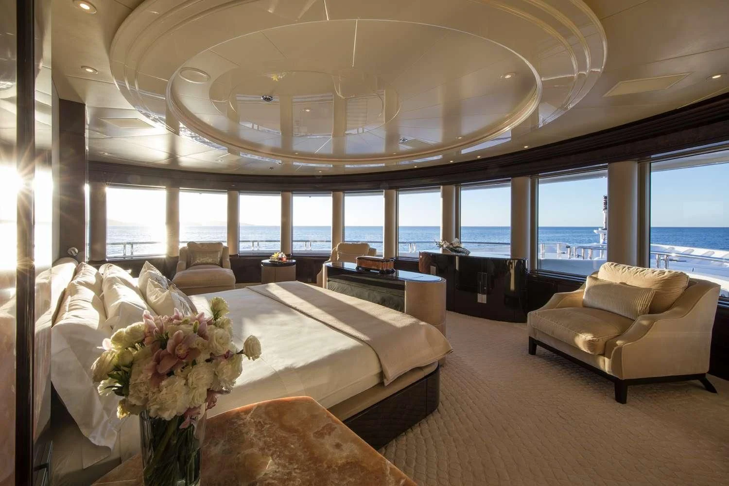 a large room with a bed and a large window aboard EMINENCE Yacht for Sale