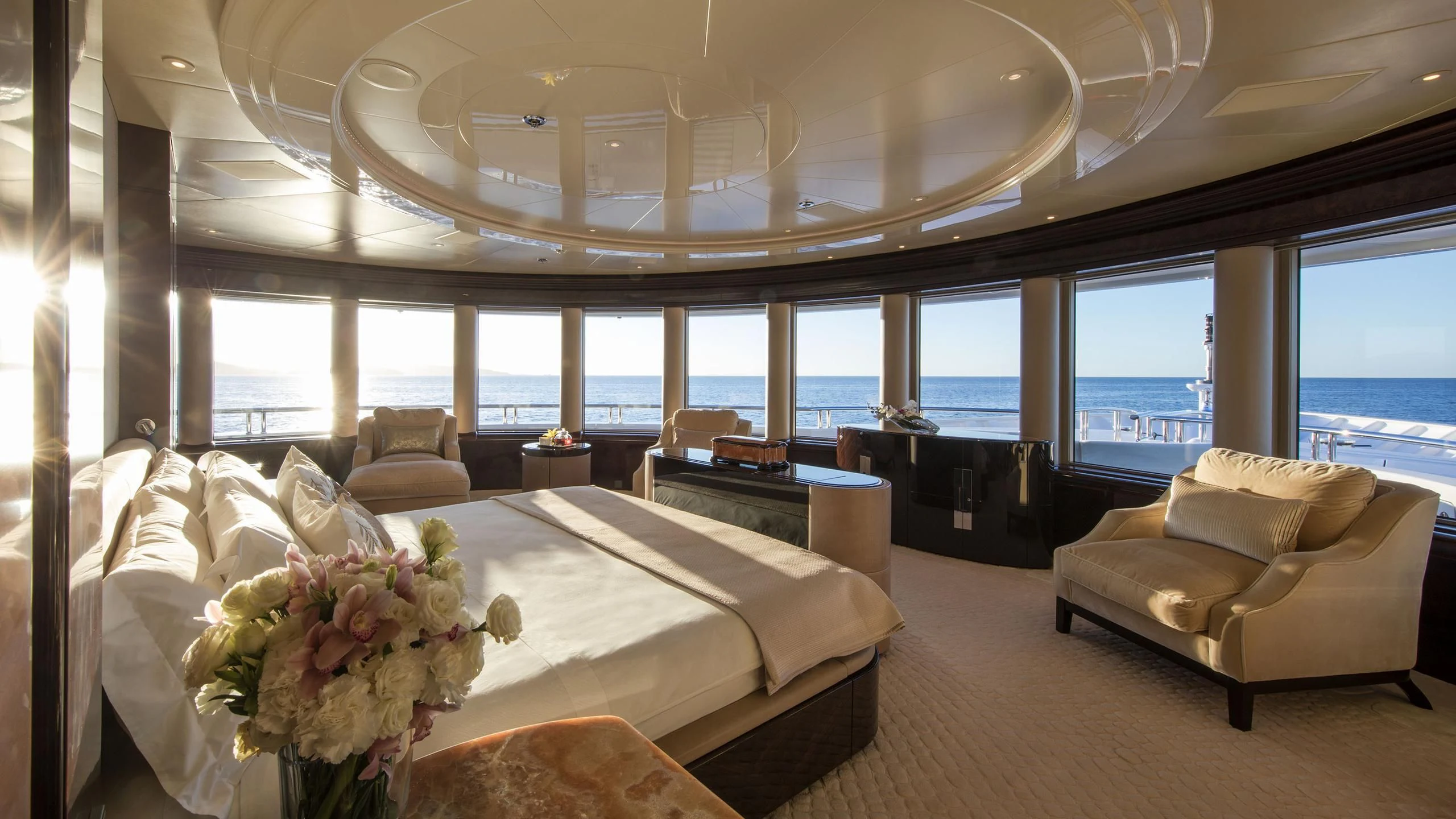 a room with a bed and a couch aboard EMINENCE Yacht for Sale