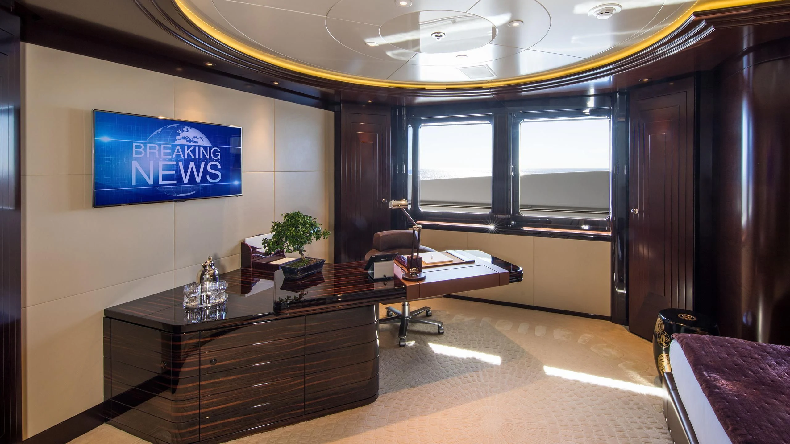 a room with a desk and a tv aboard EMINENCE Yacht for Sale